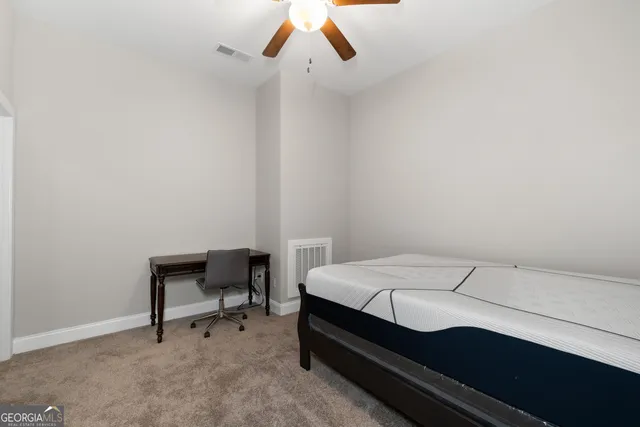 a bedroom with a bed and a desk