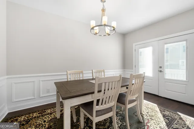 a view of a dining room with furniture and chandelier
