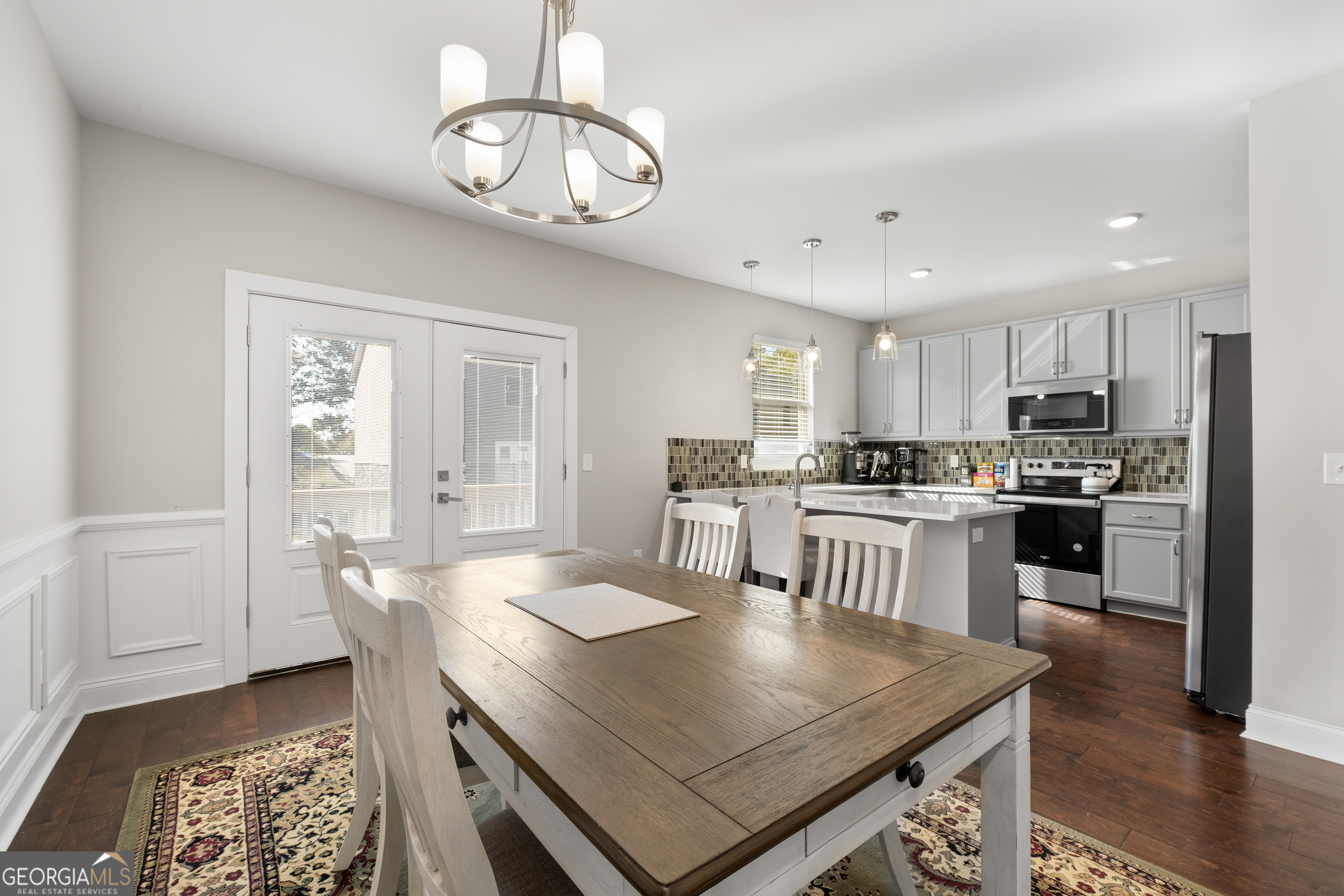 3775 Jack Vernon Circle Powder Springs, GA 30127 - Photo 10 of 33 a kitchen with a table chairs microwave and cabinets