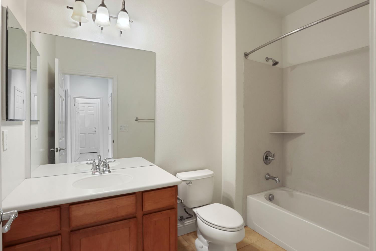 1709 Fox Trot Way Manteca, CA 95336 - Photo 11 of 24 a bathroom with a sink vanity mirror and toilet