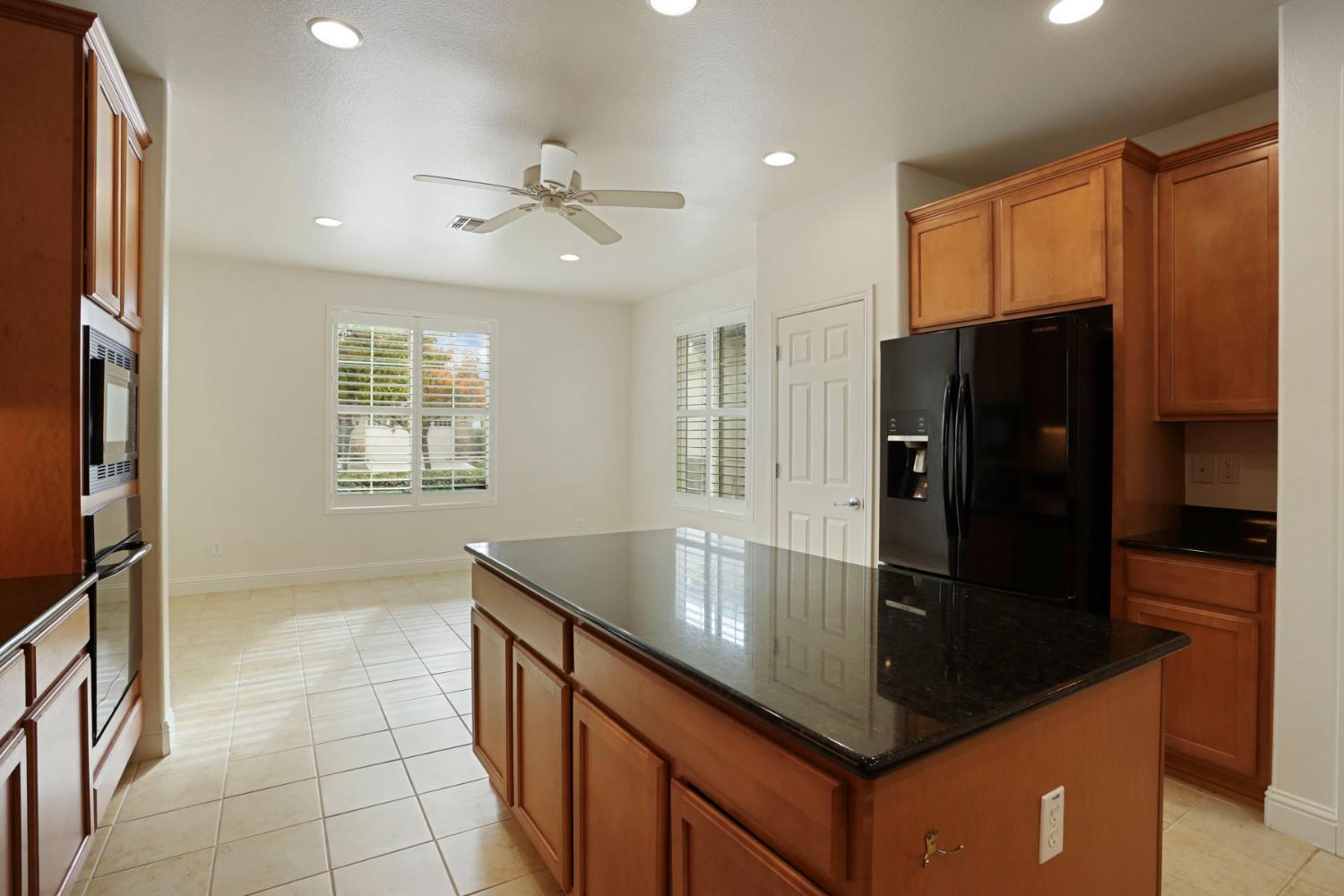 1709 Fox Trot Way Manteca, CA 95336 - Photo 5 of 24 a kitchen with stainless steel appliances granite countertop a refrigerator a sink and dishwasher