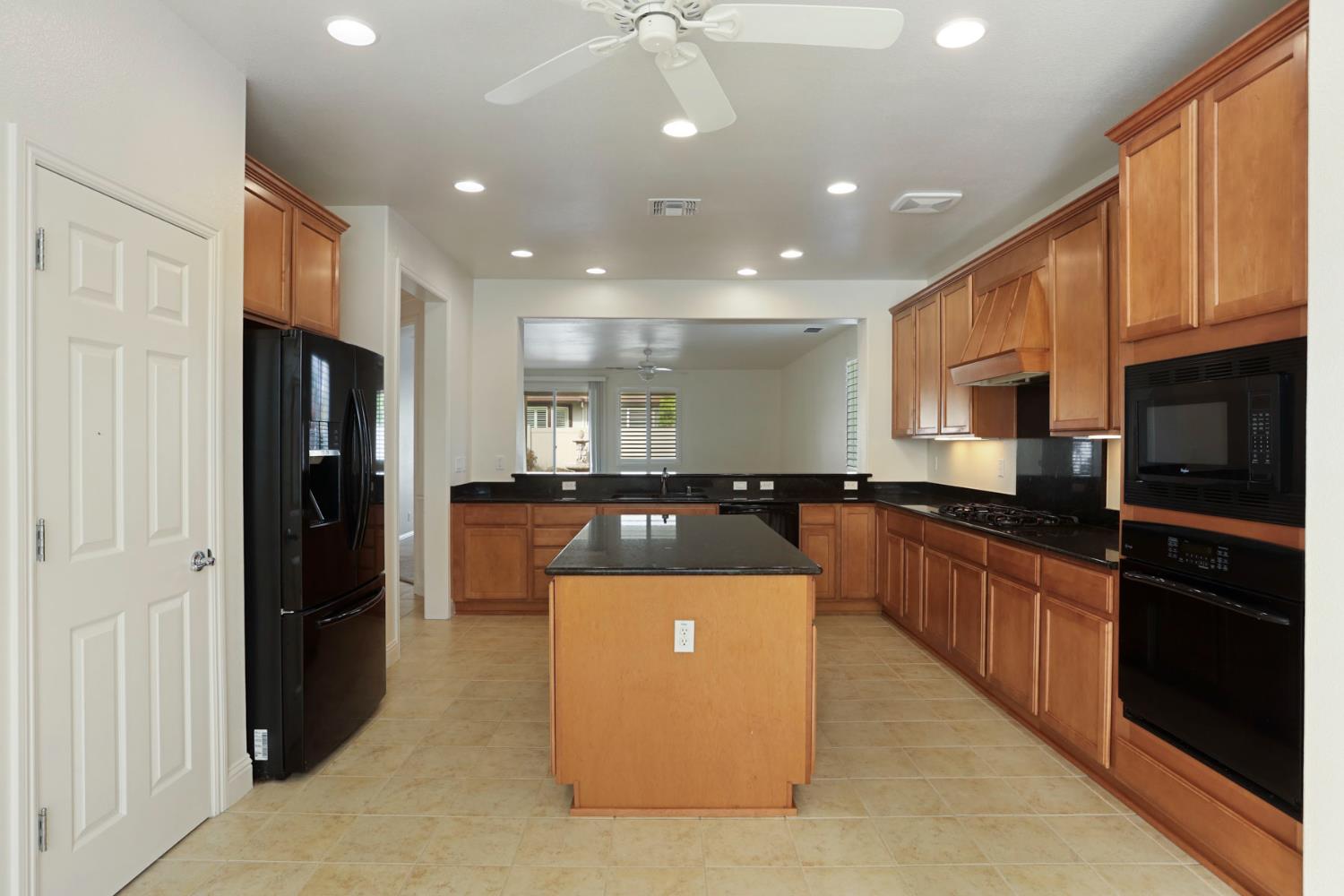 1709 Fox Trot Way Manteca, CA 95336 - Photo 6 of 24 a large kitchen with stainless steel appliances granite countertop a refrigerator and a stove top oven