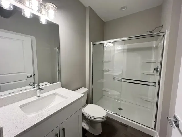 a bathroom with a sink toilet and shower