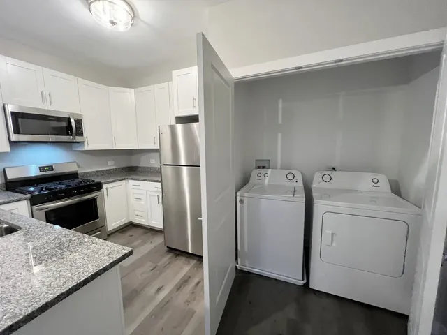 a kitchen with a refrigerator sink and stove