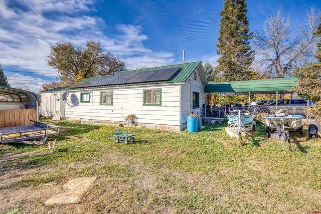 a backyard of a house with garden and patio