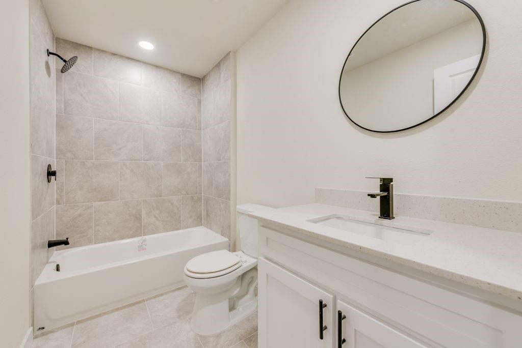 3414 Vilbig Road Dallas, TX 75212 - Photo 13 of 27 a bathroom with a sink a toilet and a mirror