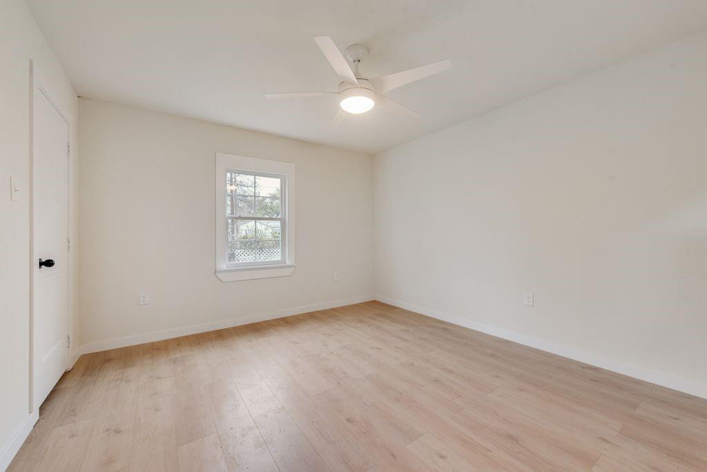 3414 Vilbig Road Dallas, TX 75212 - Photo 19 of 27 a view of an empty room with wooden floor and a window