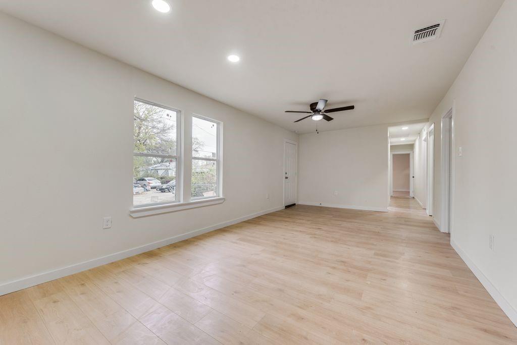 3414 Vilbig Road Dallas, TX 75212 - Photo 5 of 27 an empty room with windows and ceiling fan