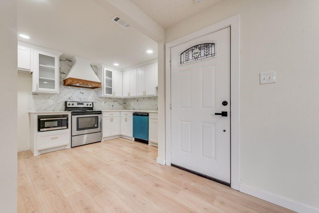 3414 Vilbig Road Dallas, TX 75212 - Photo 7 of 27 a kitchen with stainless steel appliances granite countertop a stove a sink and a refrigerator