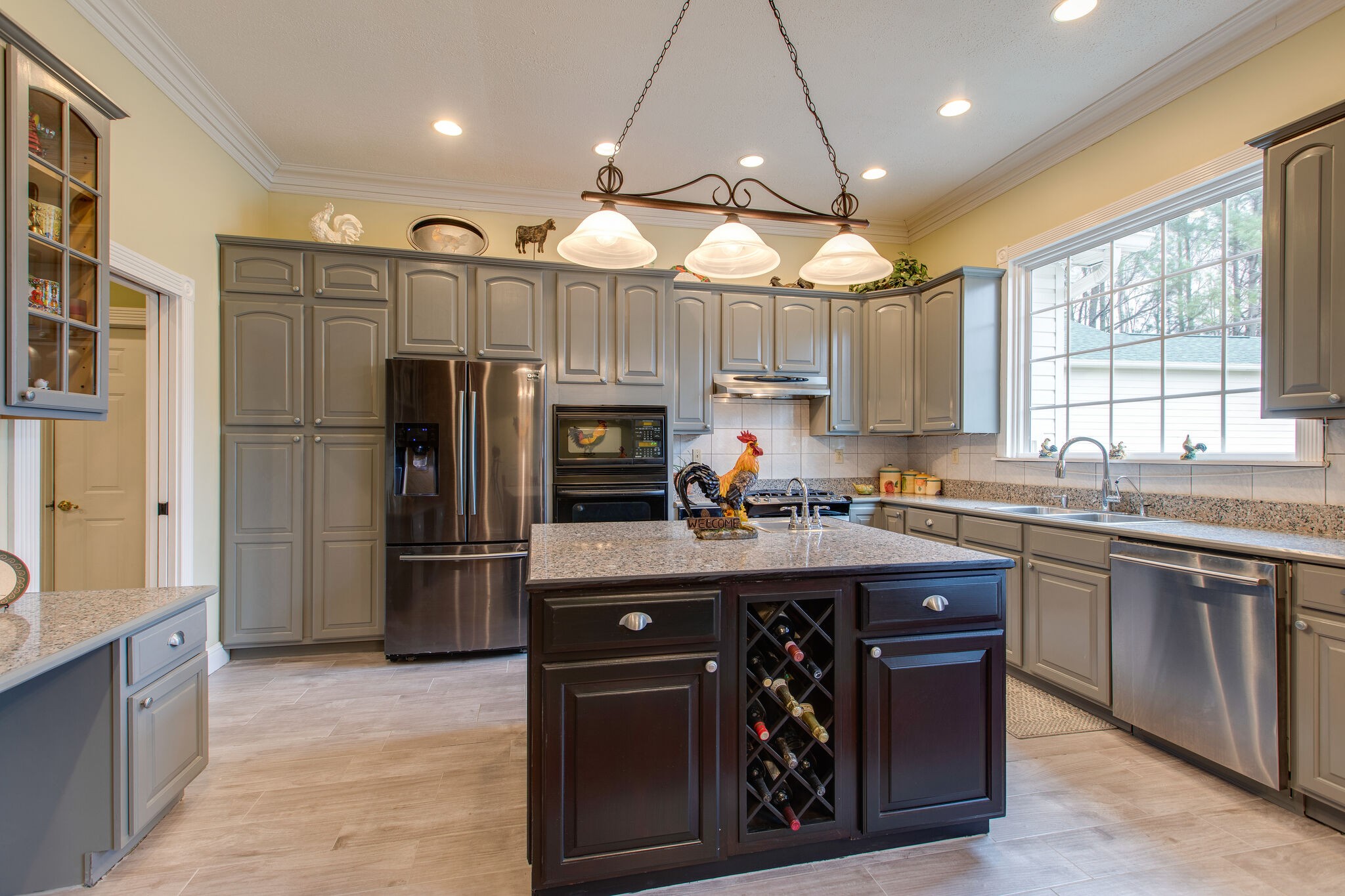 7217 Kingston Road Fairview, TN 37062 - Photo 16 of 50 a kitchen with stainless steel appliances granite countertop a sink a stove a refrigerator cabinets and a large window