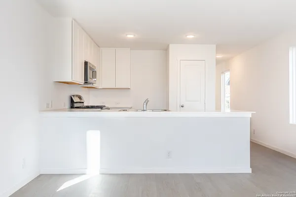 a close view of kitchen island a sink a stove and a refrigerator