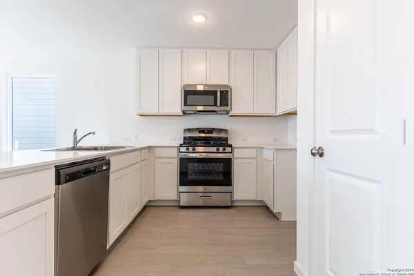 a kitchen with a sink and a stove