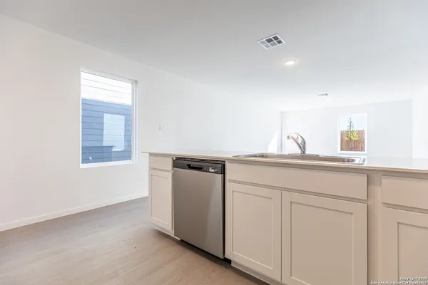 a kitchen with a sink and cabinets