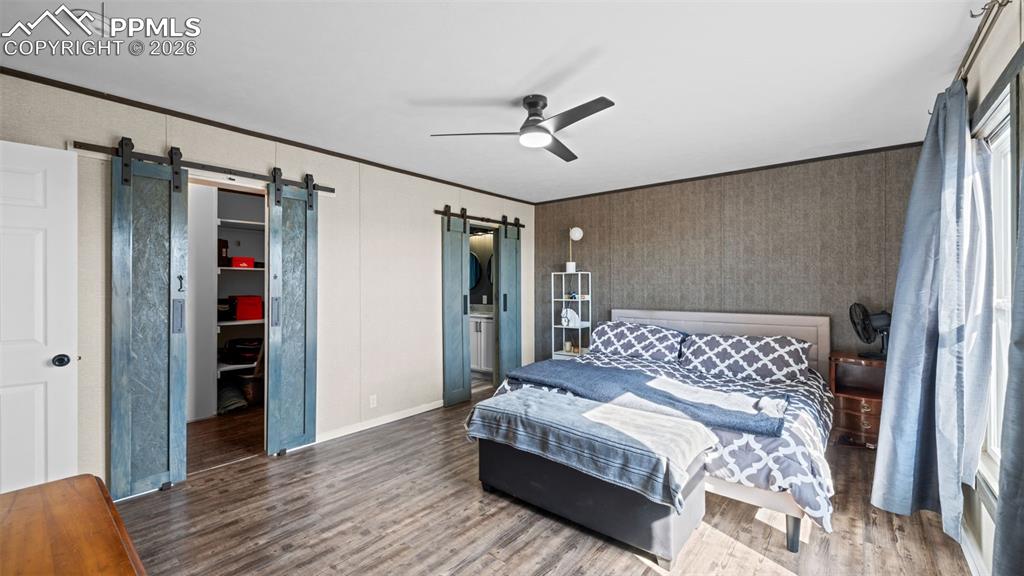 810 Awesome View Yoder, CO 80864 - Photo 16 of 43 a bedroom with a large bed and a wooden floor