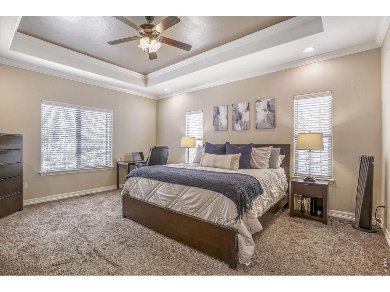 7992 St Street Frederick, CO 80530 - Photo 13 of 28 a spacious bedroom with a bed and a chandelier