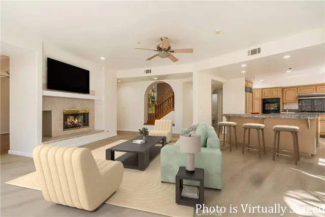 a living room with fireplace furniture and a flat screen tv