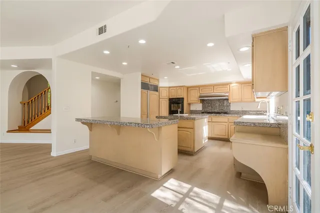 a kitchen with white cabinets and appliances
