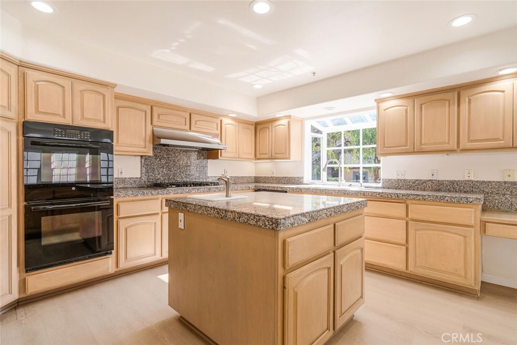 78 North Coolwater Road Bell Canyon, CA 91307 - Photo 18 of 46 a kitchen with stainless steel appliances granite countertop a stove sink and cabinets