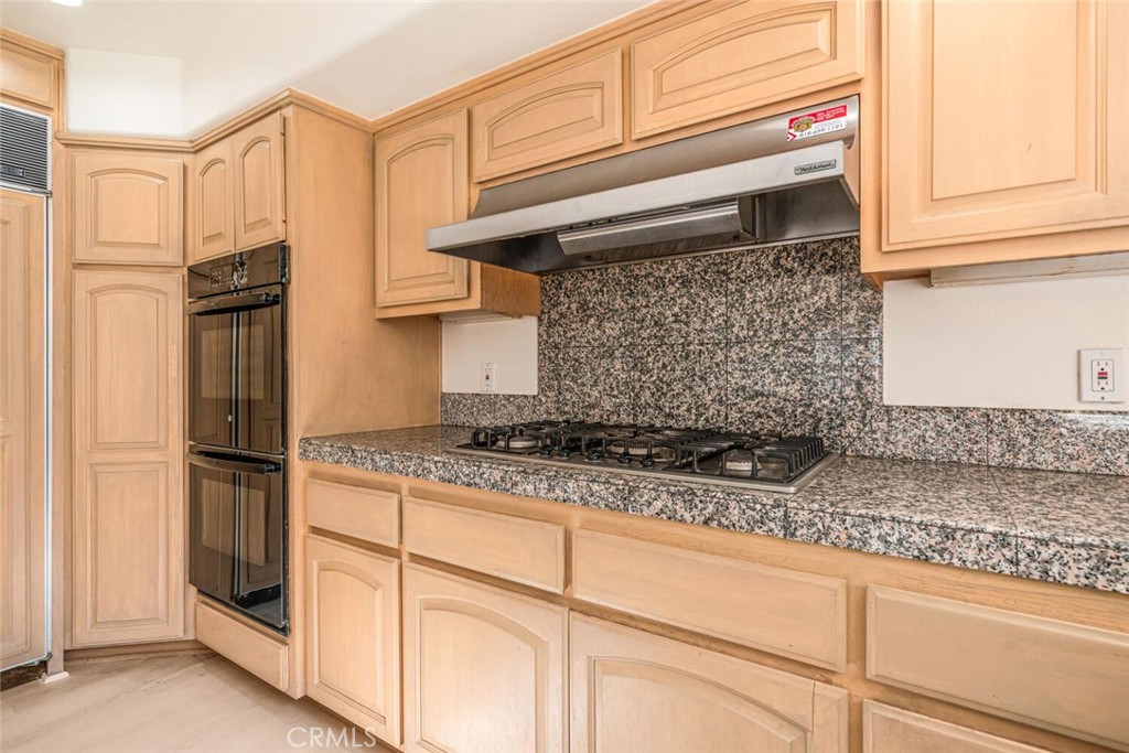78 North Coolwater Road Bell Canyon, CA 91307 - Photo 20 of 46 a kitchen with granite countertop cabinets stainless steel appliances and a counter space