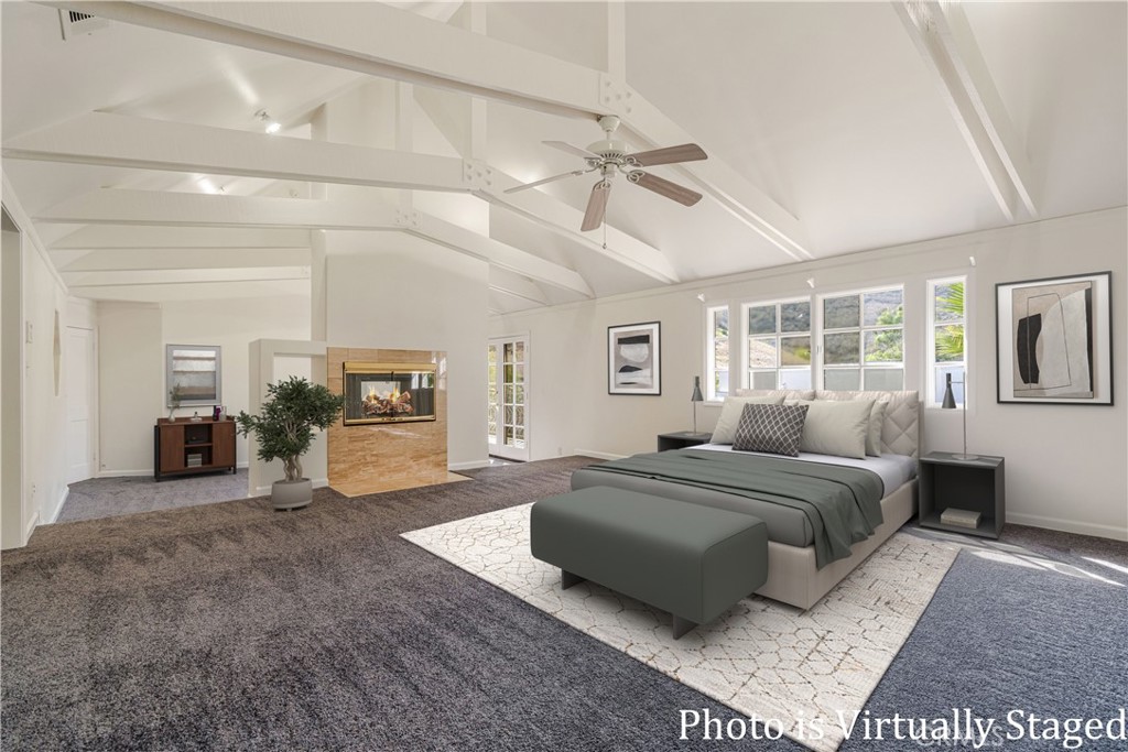 78 North Coolwater Road Bell Canyon, CA 91307 - Photo 27 of 46 a spacious bedroom with a balcony a bed and a chandelier