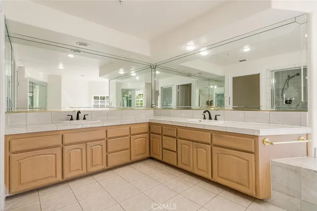 a spacious bathroom with a granite countertop sink mirror and