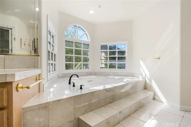 a bath tub sitting next to a window