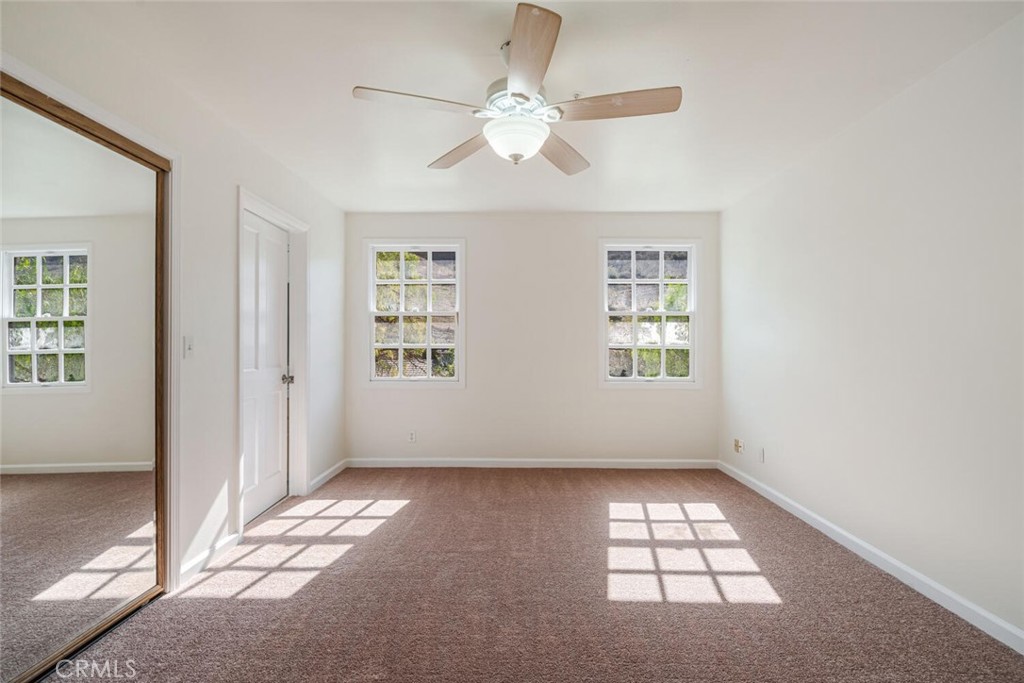 78 North Coolwater Road Bell Canyon, CA 91307 - Photo 35 of 46 an empty room with windows and ceiling fan