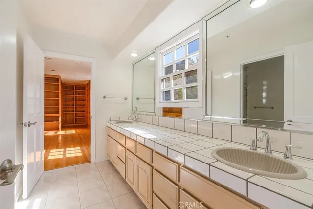 a bathroom with a granite countertop sink and a shower