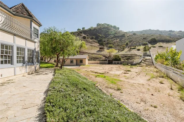 a view of a house with a yard and mountain