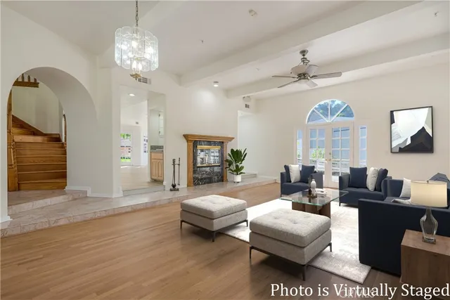 a living room with fireplace furniture and a chandelier