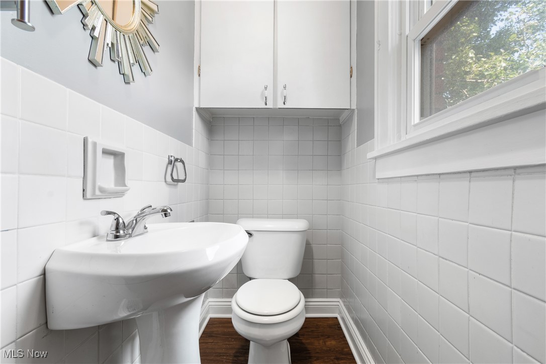 302 Poplar Avenue Northwest Canton, OH 44708 - Photo 16 of 34 Half bathroom featuring tile walls and wood finished floors