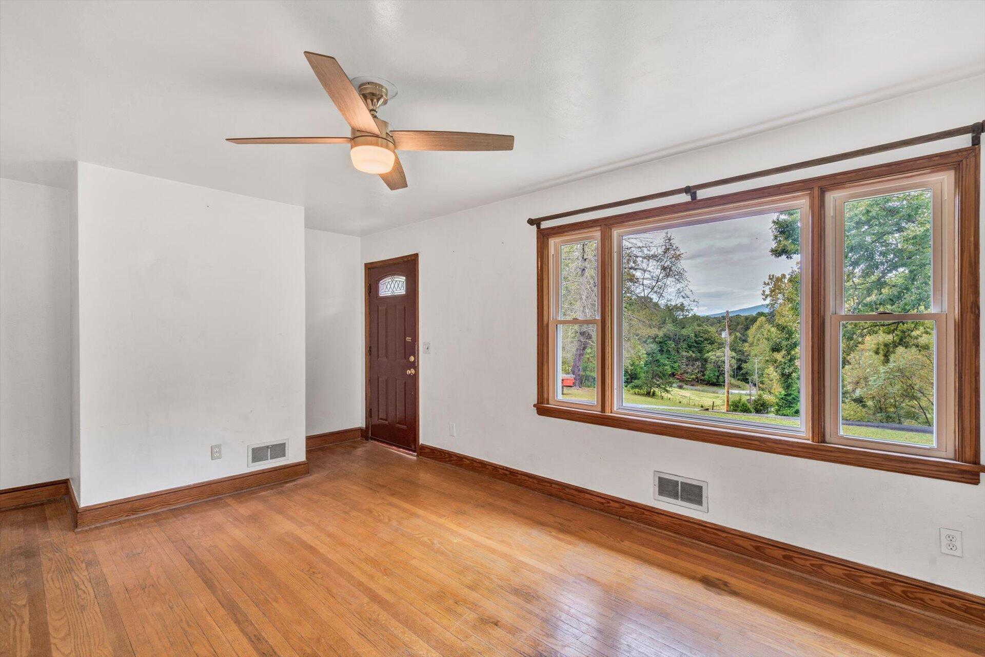 3526 Rutrough Road Southeast Roanoke, VA 24014 - Photo 11 of 33 a view of an empty room with wooden floor and a window