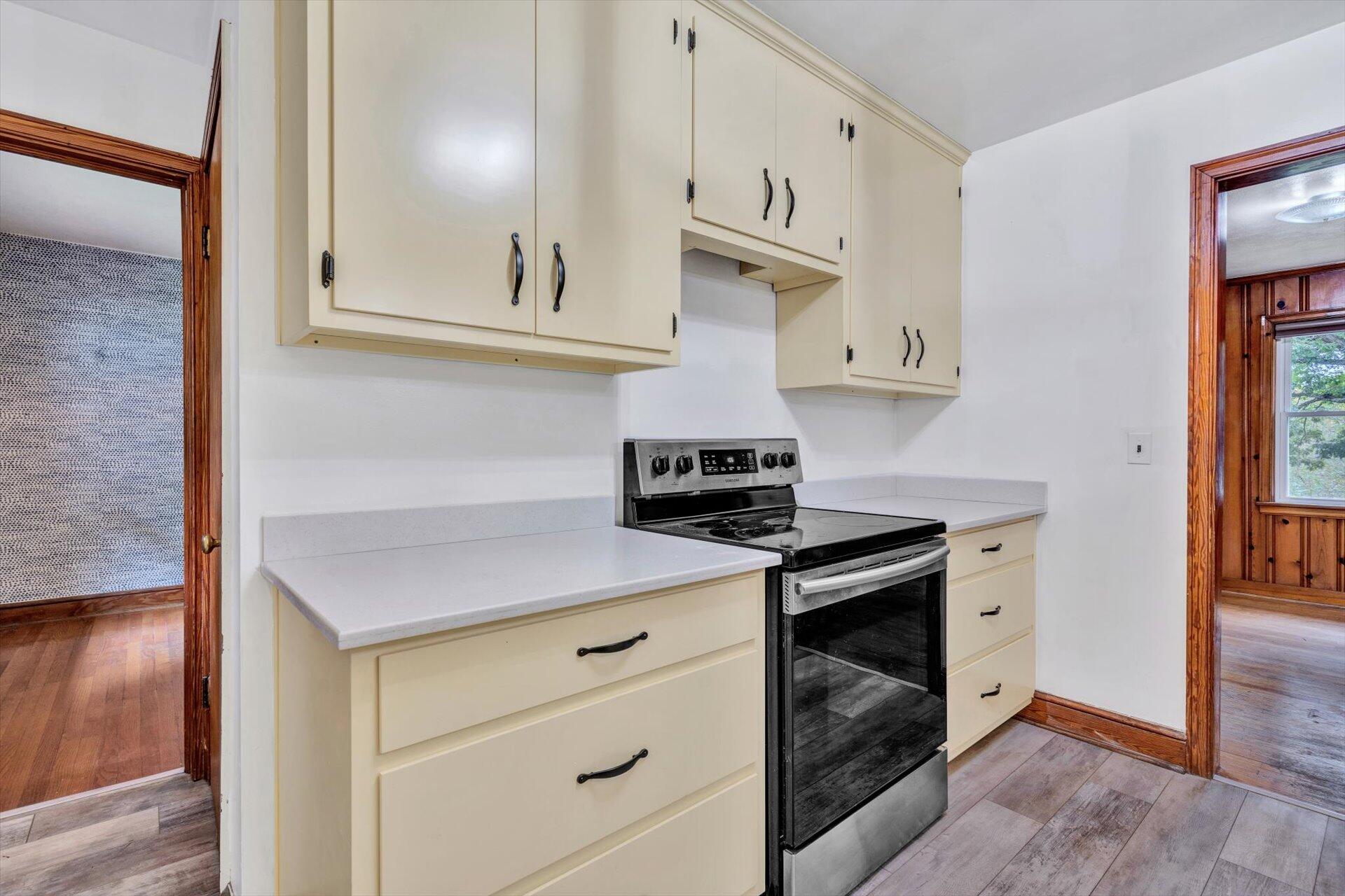3526 Rutrough Road Southeast Roanoke, VA 24014 - Photo 16 of 33 a kitchen with white cabinets and appliances