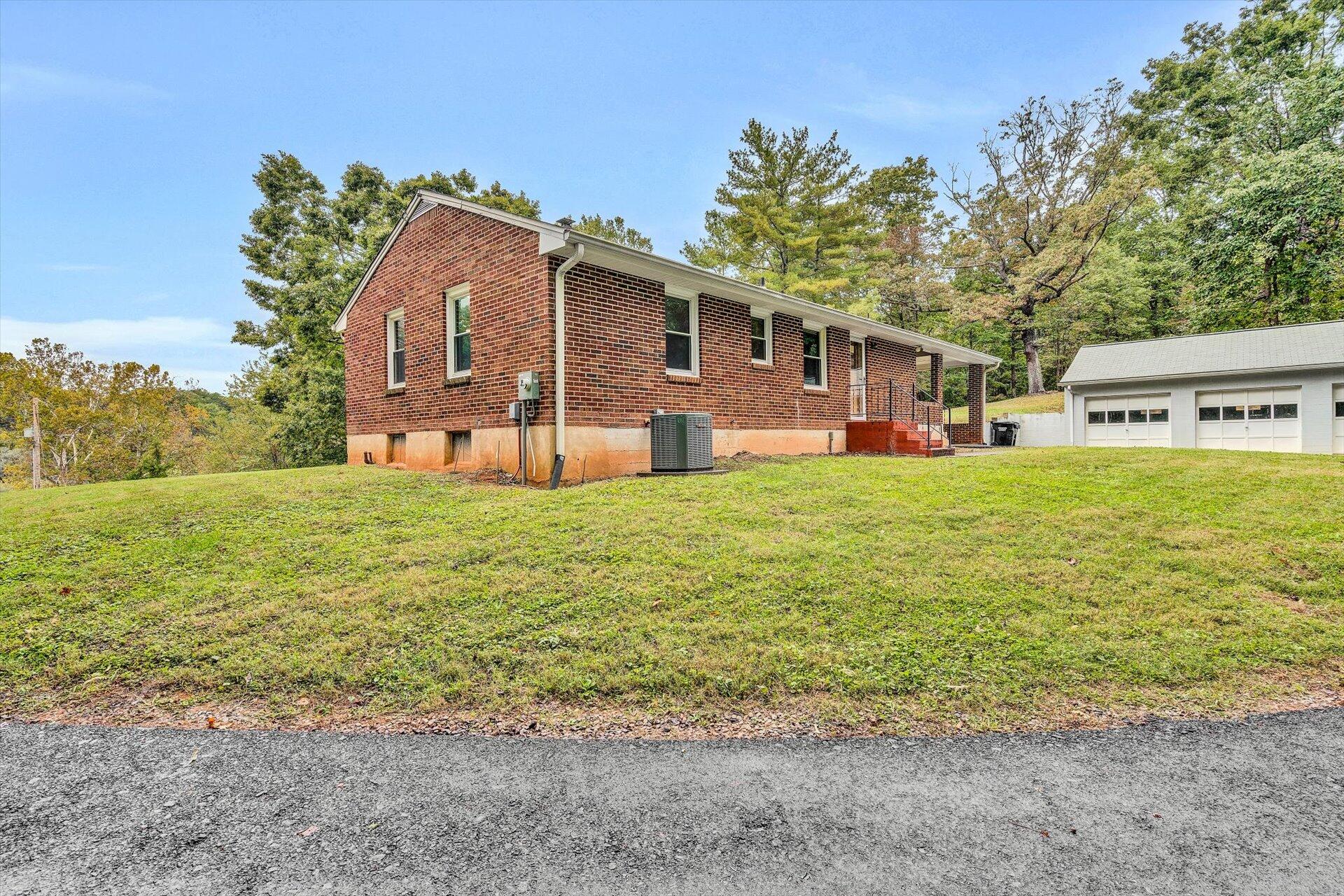3526 Rutrough Road Southeast Roanoke, VA 24014 - Photo 30 of 33 a view of a house with a big yard and large tree