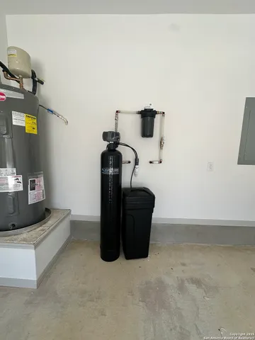 an empty room with windows and chandelier