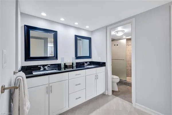a bathroom with double sink and a mirror