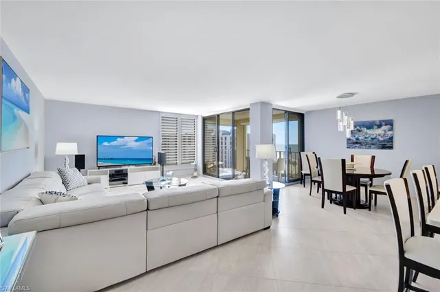 a living room with furniture a table and a flat screen tv