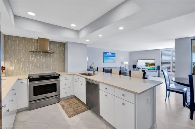 a kitchen with a sink appliances and cabinets