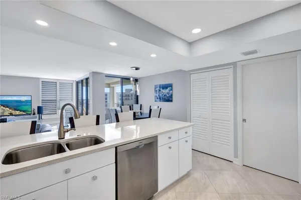 a kitchen with sink and mirror