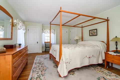 a bed room with a bed and a dresser