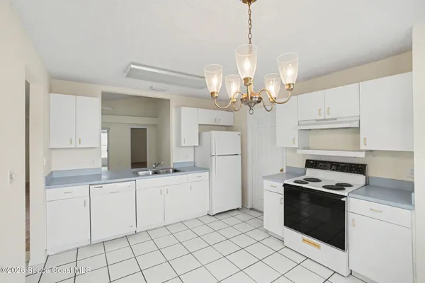 a kitchen with cabinets a sink and appliances