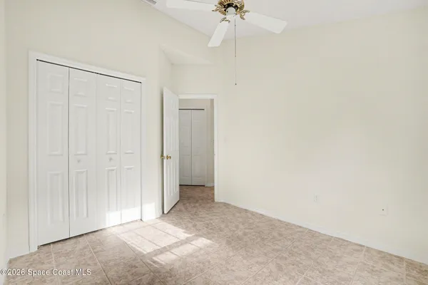 a view of a room with a chandelier fan