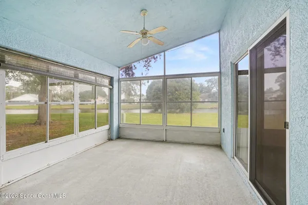 a view of an empty room with windows