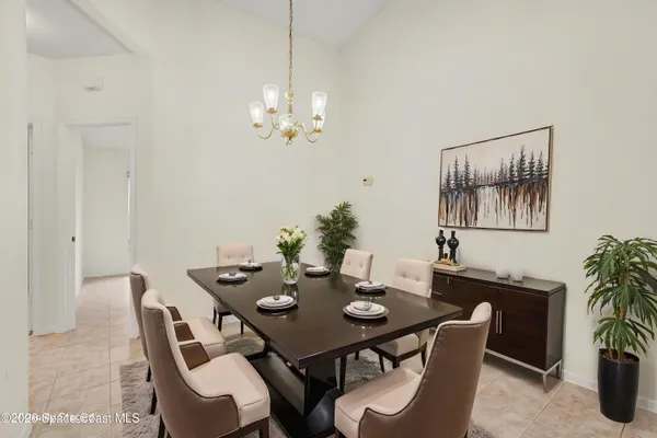 a view of a dining room with furniture window and flowerpot