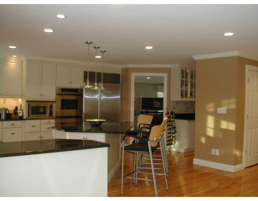 53 Fenwick Road Newton, MA 02468 - Photo 3 of 13 a kitchen with stainless steel appliances kitchen island granite countertop a refrigerator and a stove