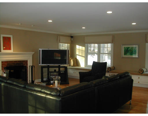 53 Fenwick Road Newton, MA 02468 - Photo 6 of 13 a living room with fireplace furniture and a flat screen tv