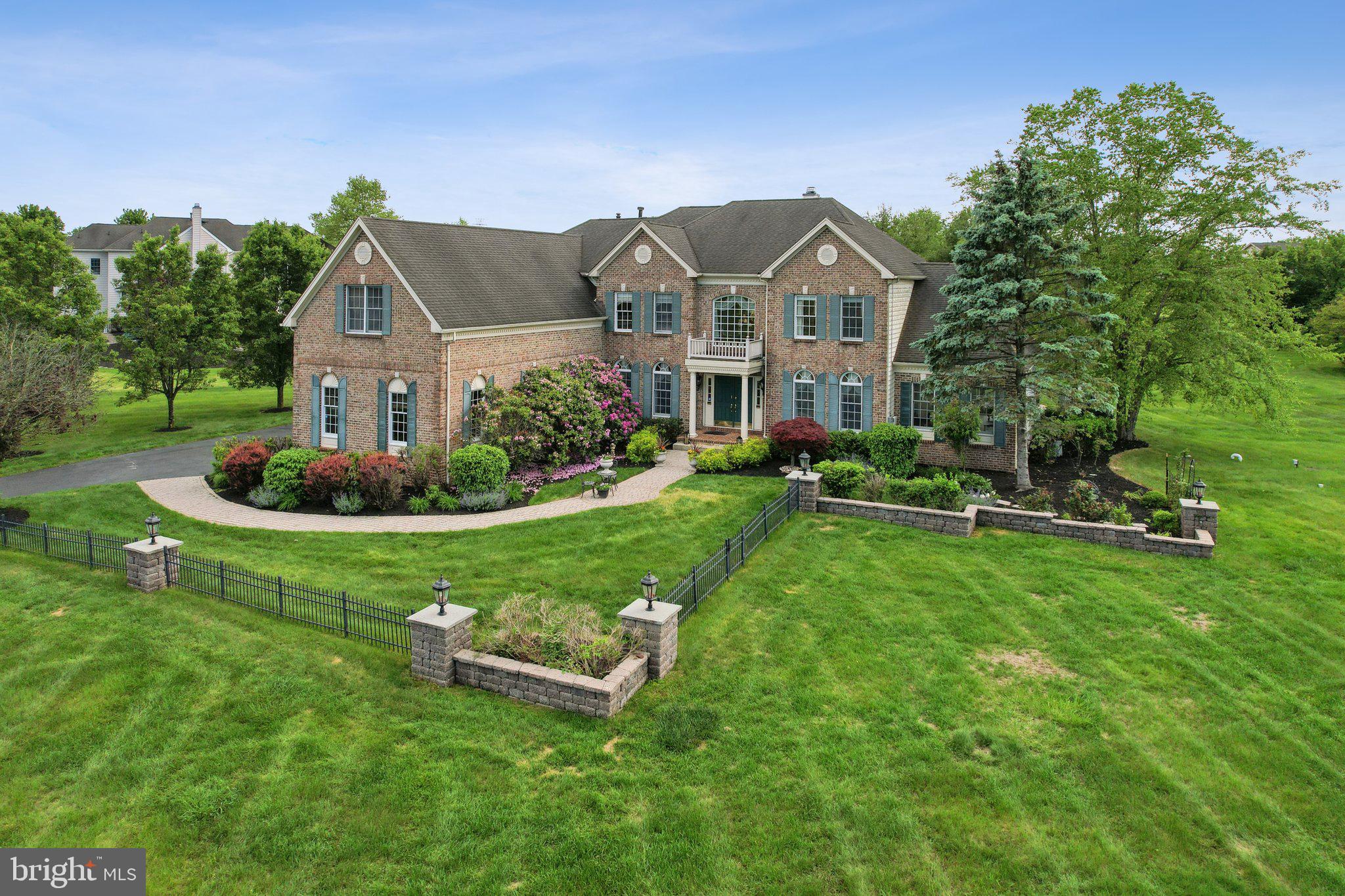 1 Baker Way Pennington, NJ 08534 - Photo 61 of 77 a front view of a house with a garden and trees