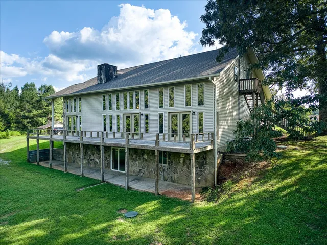 a view of an empty room with a window and fireplace