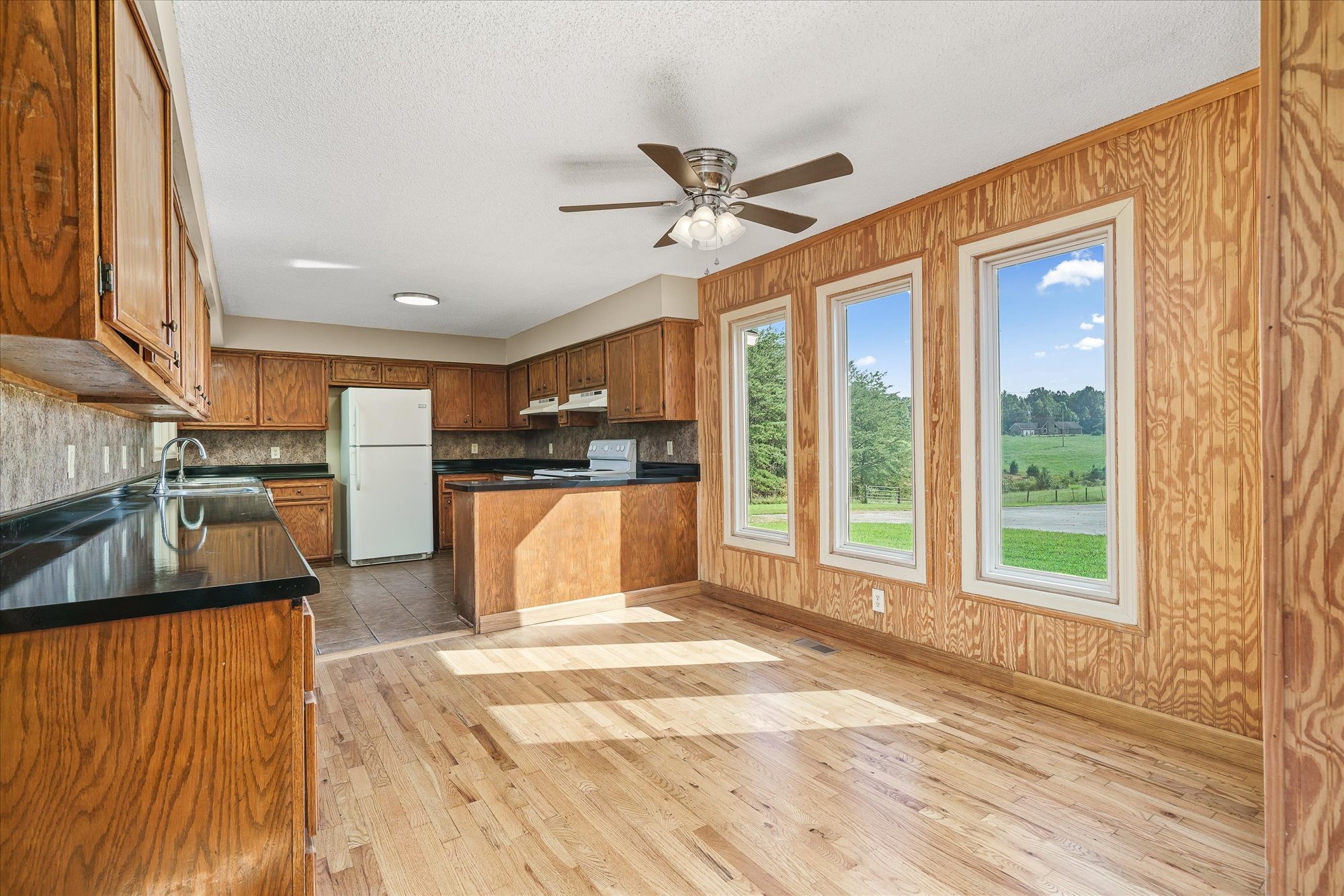 3916 Indian Mound Road Sparta, TN 38583 - Photo 15 of 48 a view of a kitchen with kitchen island a large window cabinets a sink and stainless steel appliances