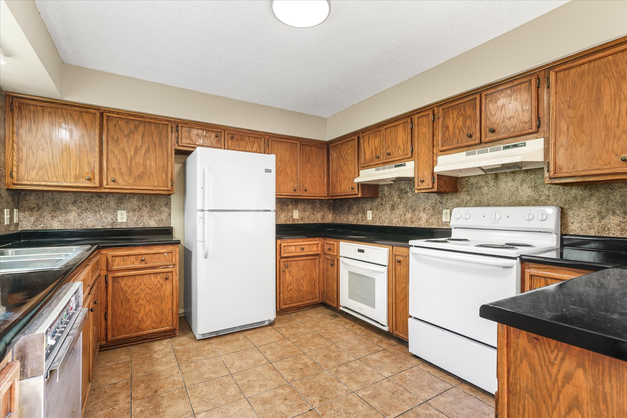 3916 Indian Mound Road Sparta, TN 38583 - Photo 17 of 48 a kitchen with stainless steel appliances granite countertop a refrigerator sink stove and oven